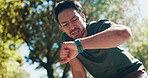 Nature, man and tired with smart watch for fitness, workout and time for wellness performance. Outdoor, male person and runner with rest to check clock, running results and exercise with breathing