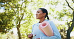 Woman, walking and nature with water or yoga mat for workout, outdoor exercise or fresh air. Active, female person or yogi with smile in wonder or fitness for health, wellness or pilates at park
