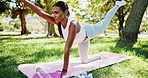 Yoga, girl and stretching on mat at park with sunbird pose for core strength, spine flexibility or balance. Pilates, yogi or woman with holistic workout in nature for fitness, wellness or mindfulness
