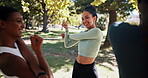 Nature, fitness and group of athletes stretching for running, workout or marathon training. Outdoor, sports and female people with arm warm up for race, challenge or activity for health in park.