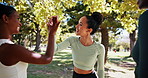 Nature, fitness and group of women with high five for running, workout or marathon training. Outdoor, sports and female athletes with achievement for race, challenge or activity for health in park.