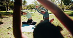 Yoga, women and instructor stretching at park with holistic exercise for core strength, body flexibility or balance. Pilates, class and instructions with workout in nature for fitness and mindfulness