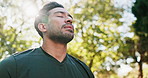 Meditation, wellness and man with breathing by park for mindfulness, healing aura or spiritual mental health. Flare, below or peaceful in nature with fresh air, face or eyes closed for energy balance