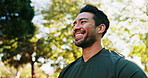 Fitness, happy and man in nature for workout, running or training for health or wellness. Low angle, sports and athlete with preparing for cardio exercise outdoor in park with breathing for warm up.