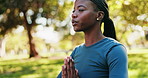 Yoga, praying hands and woman with meditation by park for mindfulness, healing aura or holistic wellness. Zen, black person and peaceful in nature with fresh air, calm or breathing for energy balance