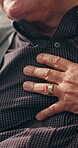 Senior man, hands and massage chest pain for hypertension, artery pressure or discomfort in home. Closeup, elderly person and symptoms of medical emergency with cardiac arrest, heart attack or crisis