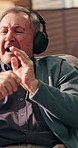 Senior man, headphones and dancing on sofa, home and relax with smile, streaming and sound in lounge. Elderly person, singing and listening to music, subscription and audio in retirement at apartment