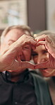 Old couple, heart and hands for love in home, happiness and support in marriage with symbol for affection. Trust, loyalty and connection with gesture for care, wellness and senior people for romance