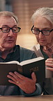 Home, talking or old couple reading bible for God in spiritual religion for peace, guidance and learning. Senior, retirement or people with literature, scripture and book with prayer, faith or gospel