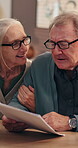 Old couple, talking and paperwork in home for retirement finance, life insurance or asset management discussion. Elderly man, woman and story with documents for policy, pension fund or annuity 