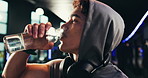 Man, thirsty and drinking water in gym for health, fitness or post workout beverage, electrolytes and nutrition. Breathing, relief and self care with liquid in bottle for h2o, refresh and detox