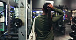 Back, walking and woman in gym, fitness and confidence with health facility, training and exercise. Person, pride and wellness center with equipment, workout and energy with membership and start
