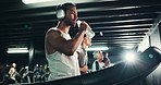 Headphones, sweating and man on treadmill with water in gym for run, exercise and endurance with fatigue. Cardio, tired runner and machine with drink for thirst, intense and music at fitness center