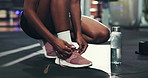 Hands, shoes and laces in gym for fitness, run or start exercise routine with water for health. Person, athlete and ready for workout, training or sports with tying sneakers for preparation at club