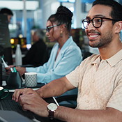 Computer, smile and typing with programmer at desk in office as graphic ...