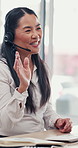 Business, waving and Asian woman in video call for customer service, help or communication. Computer, smile and mature consultant with greeting in virtual meeting for sales or telemarketing in office