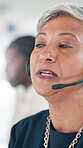 Call center, mature woman and customer service on headset in office, communication and crm help. Coworking, business person and female consultant with advice for faq support, consulting and talking