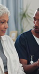 Tablet, checkup and nurse with senior woman in home with telehealth, advice or healthcare support. Digital technology, discussion and male caregiver with elderly patient for medical service.
