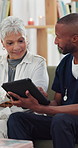 Tablet, consultation and nurse with senior patient in home with telehealth, advice or healthcare support. Digital technology, discussion and male caregiver with elderly woman for medical service.