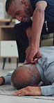 Collapse, emergency and nurse in home with old man, checking pulse and medical support. Healthcare crisis, caregiver and senior person on floor from fall, heart attack or stroke with homecare help