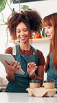 Coffee shop, talking and women on tablet in cafe for menu items, inventory and online orders. Restaurant, hospitality and people in conversation with digital tech for planning, invoice and service