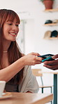 Woman, phone and pos at restaurant for payment, order and easy transaction for catering service at cafe. People, customer and smartphone with smile, tap and fintech with mobile app at coffee shop