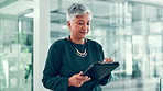 Business woman, reading and walking with tablet in office for budget report, account management or typing email. Accountant, mature person and digital app for schedule update, online search or agenda