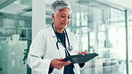 Doctor, woman and walking with tablet in hospital for treatment research, healthcare news or medical chart review. Medicine, mature person and digital records for telehealth and check online results