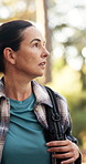 Hiking, walking and woman explore forest for travel adventure, sightseeing nature and scenery. Trekking journey, mature person and backpack in woods with holiday tourism, wellness hobby and fresh air