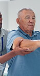 Dumbbell, physiotherapy and doctor with old man in office for rehabilitation, support and muscle injury recovery. Healing, physical therapy and healthcare consulting with senior person in clinic