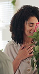 Couple, hug and flowers with smile for valentines day, love and surprise bouquet for relationship, anniversary or date. Man, woman and embrace in home with roses for marriage, celebration or present