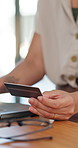 Person, hands or shopping with credit card on laptop for online transaction, payment or home banking. Closeup, shopper or user with debit on computer for ecommerce, remote purchase or buying at house