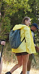Backpacking, friends and group on adventure in nature, trekking and exploration of woods or walking. Outdoor, pointing and people on journey in forest, travel and hiker with hiking poles on vacation