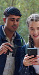 Friends, people and bird watching with phone, forest and journey with backpack. Binoculars, nature view and outdoor in rainforest with trekking, walk and internet website for search in jungle