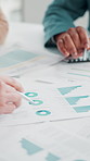 Hands, paperwork and graphs in meeting at office with review, team and investment planning with stats at company. People, documents and charts for stock market research with report at finance agency