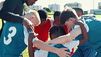 Soccer, team and children with coach in huddle for motivation, support or synergy on grass field. Group, football players or kids with trainer in circle for sports competition, tournament or game