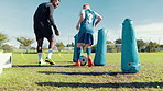 Dribble, skill or soccer with coach and kid on field for ball control, exercise or training. Children, fitness and drill with football player on sports pitch for agility, practice or technique