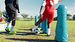 Dribble, drill or soccer with coach and kid on field for ball control, exercise or training. Children, fitness and practice with football player on sports pitch for agility, skill or technique
