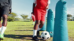 Agility, dribble or soccer with child and coach on field for ball control, exercise or training. Fitness, kids and practice with football player on sports pitch for drill, skill or technique