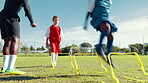 Children, jumping and coaching for soccer, fitness and training with speed hurdles, outdoor and sports. Practice, routine and kids with improved footwork for match, athlete or leg muscle for football