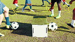Sports field, kick and training with soccer ball, legs and energy for fitness with sportswear and outdoor. Practice, routine and kids with coach for skills, active and cardio for competition or match