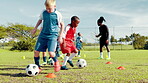 Group, kids and dribble with ball for soccer practice, training and fitness exercise. Children, equipment and drill with cones for sports workout, skills technique and learning agility for team match