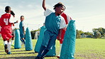 Soccer, running and boys on field for training, exercise and fitness for practice, competition and game. Team, sports and children with equipment for workout for match, tournament and challenge