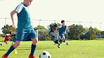 Boy, running and soccer practice on field with parachute, strength training and fitness exercise. Child, equipment and sports workout for endurance, speed challenge and cardio technique for agility
