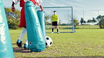 Child, dribble and ball for soccer practice with inflatable, team training and fitness exercise. Children, equipment and defence drill of sports workout, skill technique and agility of cardio routine