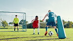 Boys, dribble and ball for soccer practice with defence, team training and fitness exercise. Children, equipment and drill  with net for sports workout, skills technique and agility for match session