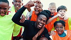 Soccer field, face and coach with children for celebration, motivation and achievement for sports game. Excited, trainer and kids with fist pump for cheering, football winning and confidence boost
