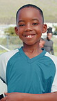 Soccer, smile and face of child on field for competition, training and sports athlete. Football player, fitness and learning with kid on outdoor pitch for game, health and tournament practice