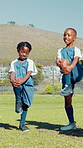 Black children, stretching and legs for soccer on field for team exercise, balance training and fitness. Kids, warm up and routine of sports preparation, game workout and performance for match skills