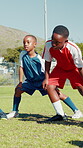 Black kids, stretching and legs for soccer on field for team exercise, balance training and fitness. Children, warm up and routine of sports preparation, game workout and performance for match skills
